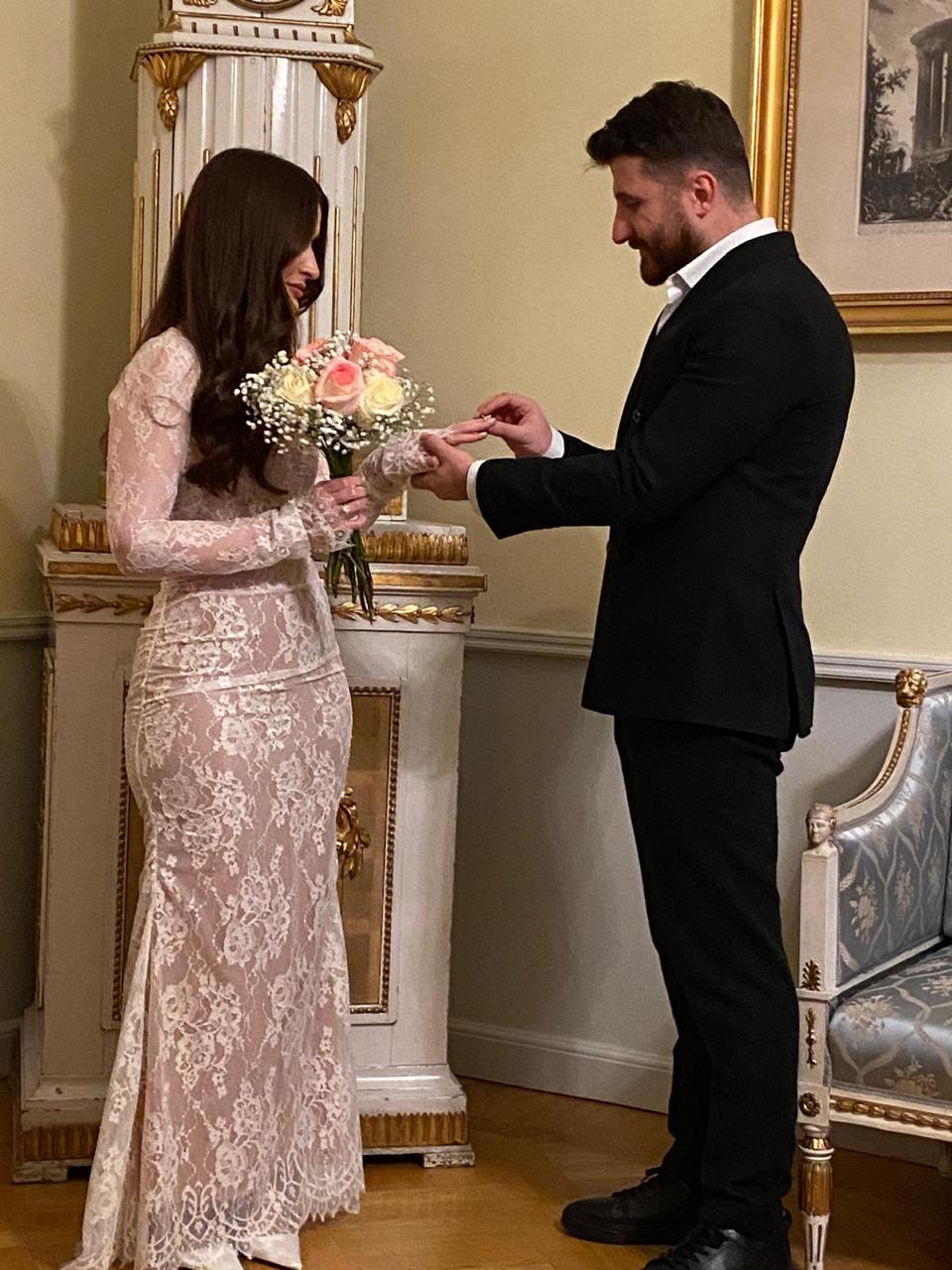 Nuhayl placing a ring on Helen's hand